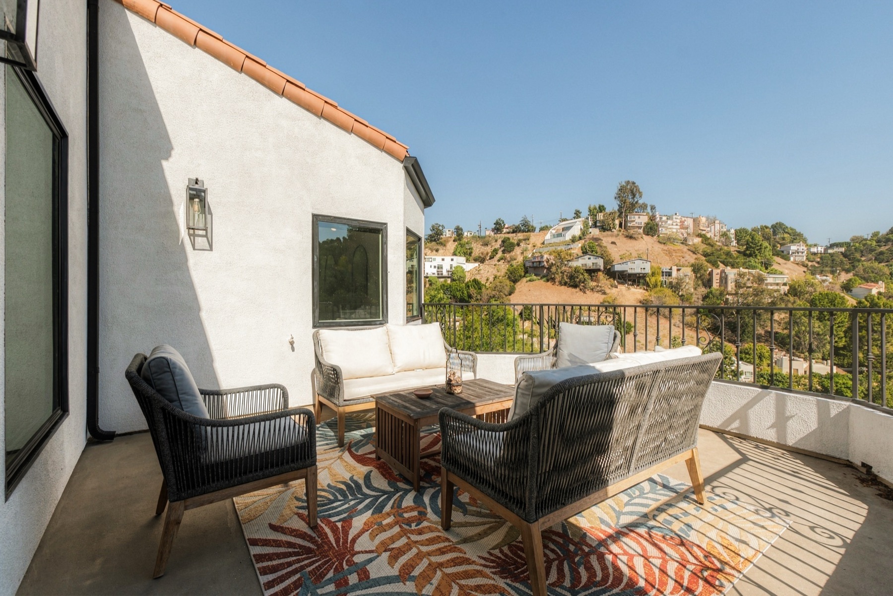 Balcony with lounge seating facing the hills
