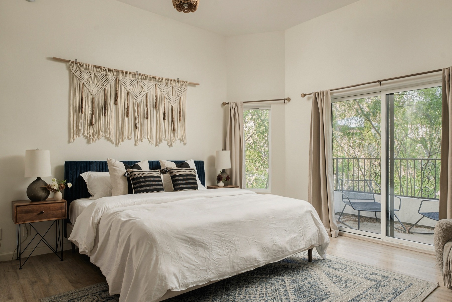 Bedroom with macrame wall hanging and balcony access