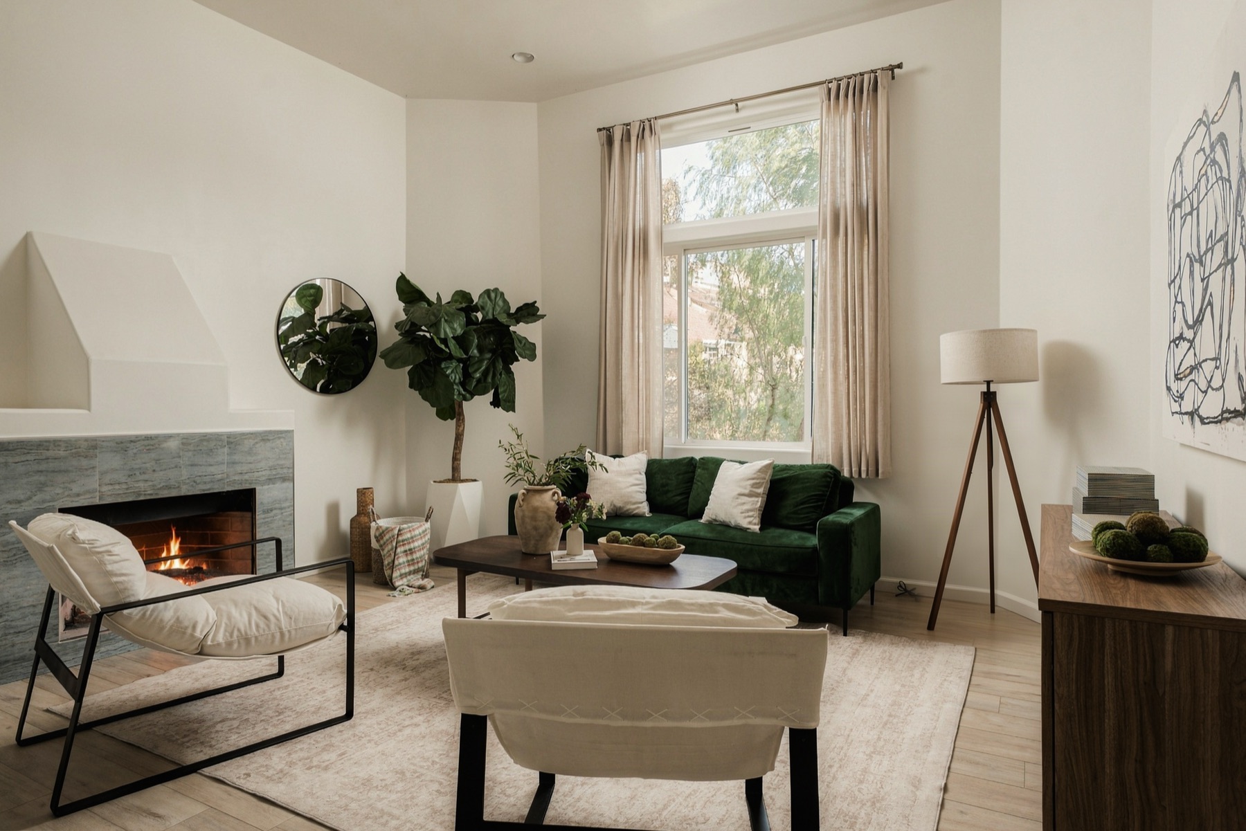 Family room with fireplace and green velvet seating