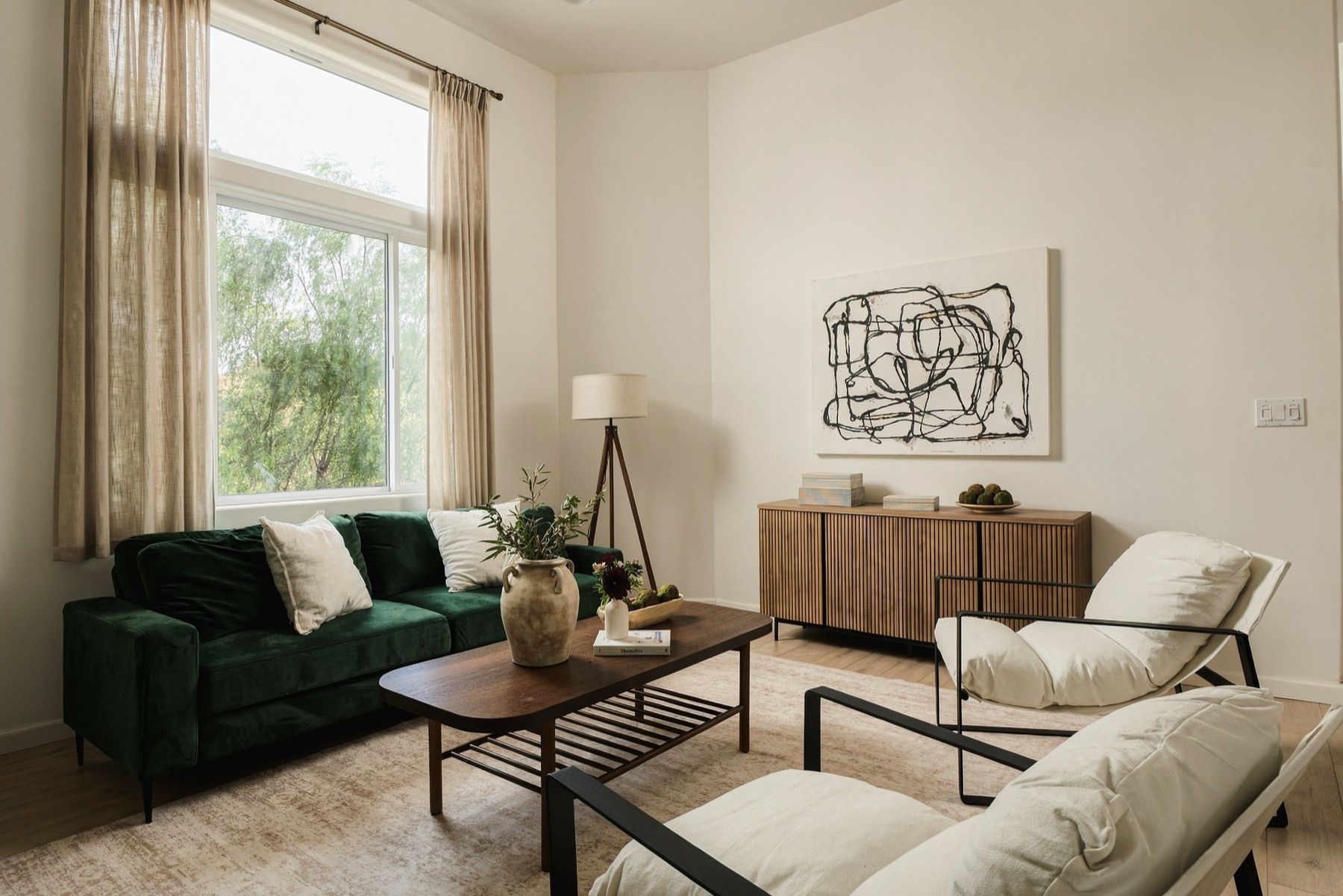 Family room with tall windows and light wood floors