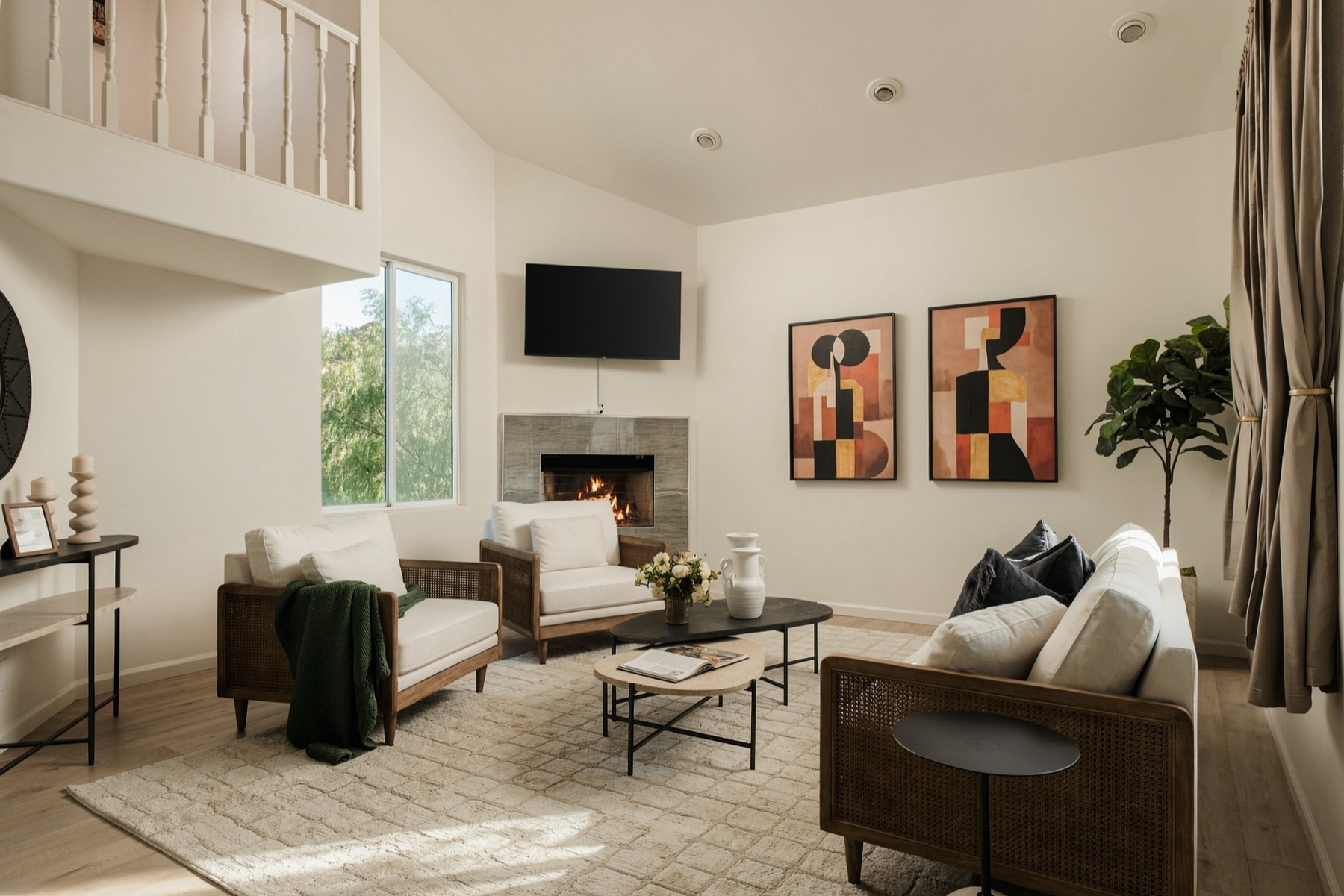 Vaulted living room at 3646 Potosi Avenue with a fireplace and a mezzanine above