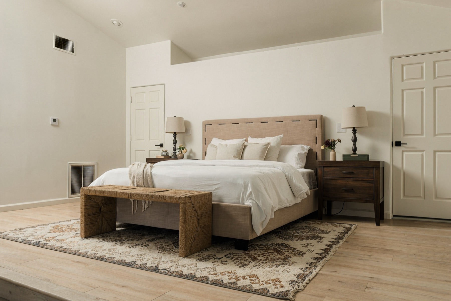 Primary bedroom with a vaulted ceiling